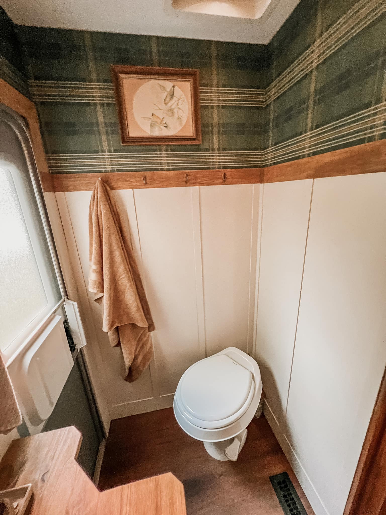 bathroom with wooden trim and decorative towel hooks
