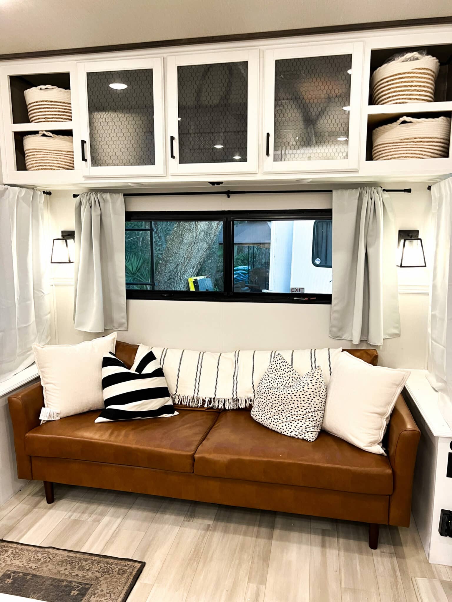 Baskets inside open shelving above a couch